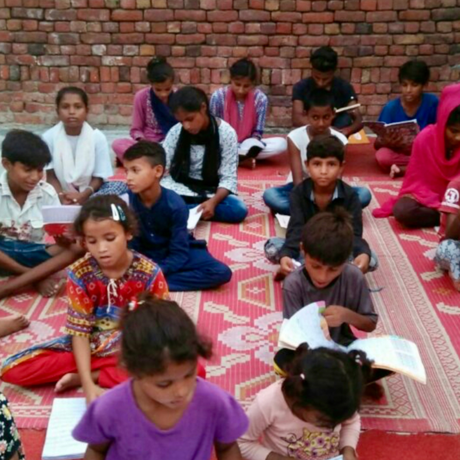 Children reading together in class, Exotic Skn Foundation.