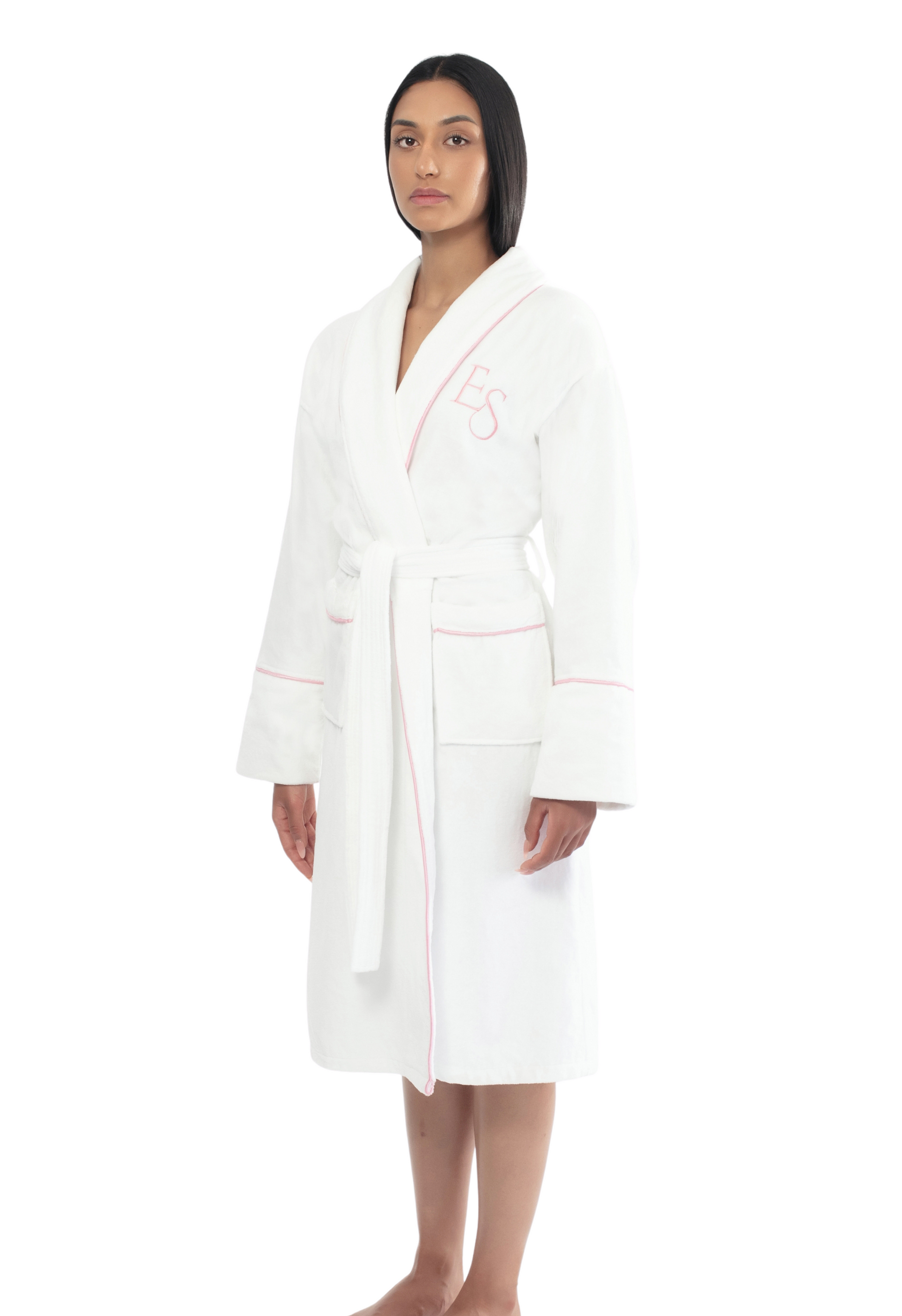Founder of Exotic Skn wearing the Ritual Robe, a white bathrobe with pink piping on a white background