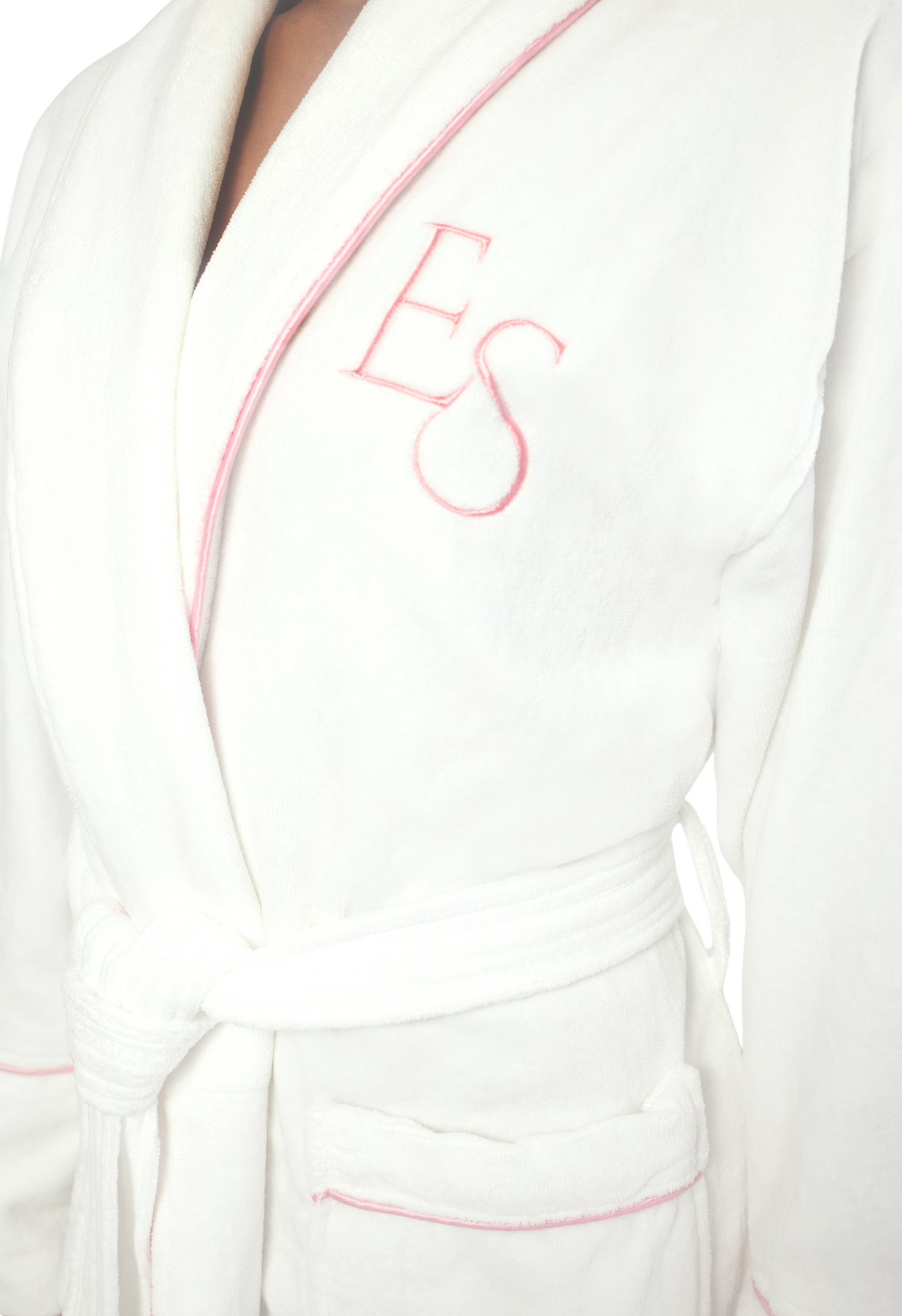 White bathrobe with pink Exotic Skn lettering on a white background