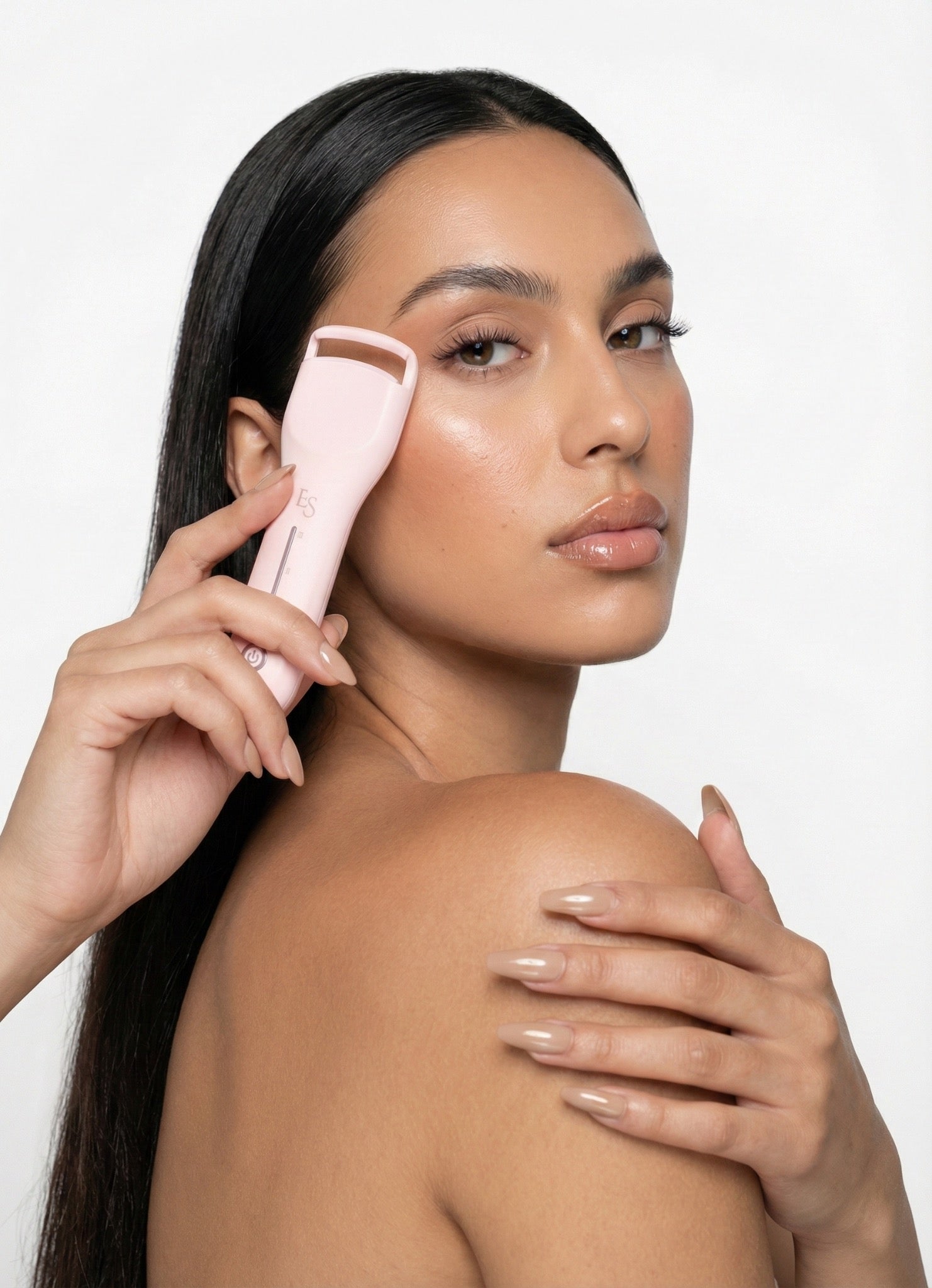Model holding Lash Alchemy™ beside lifted lashes