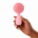 Dream Skin Cleanser held in one hand to show its scale
